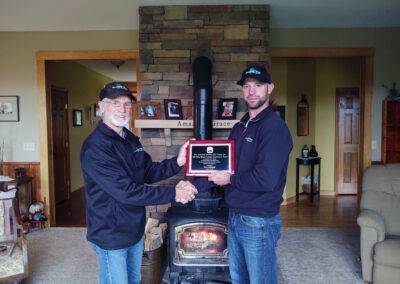 ceo jared webber and his father receiving plaque recognizing their work